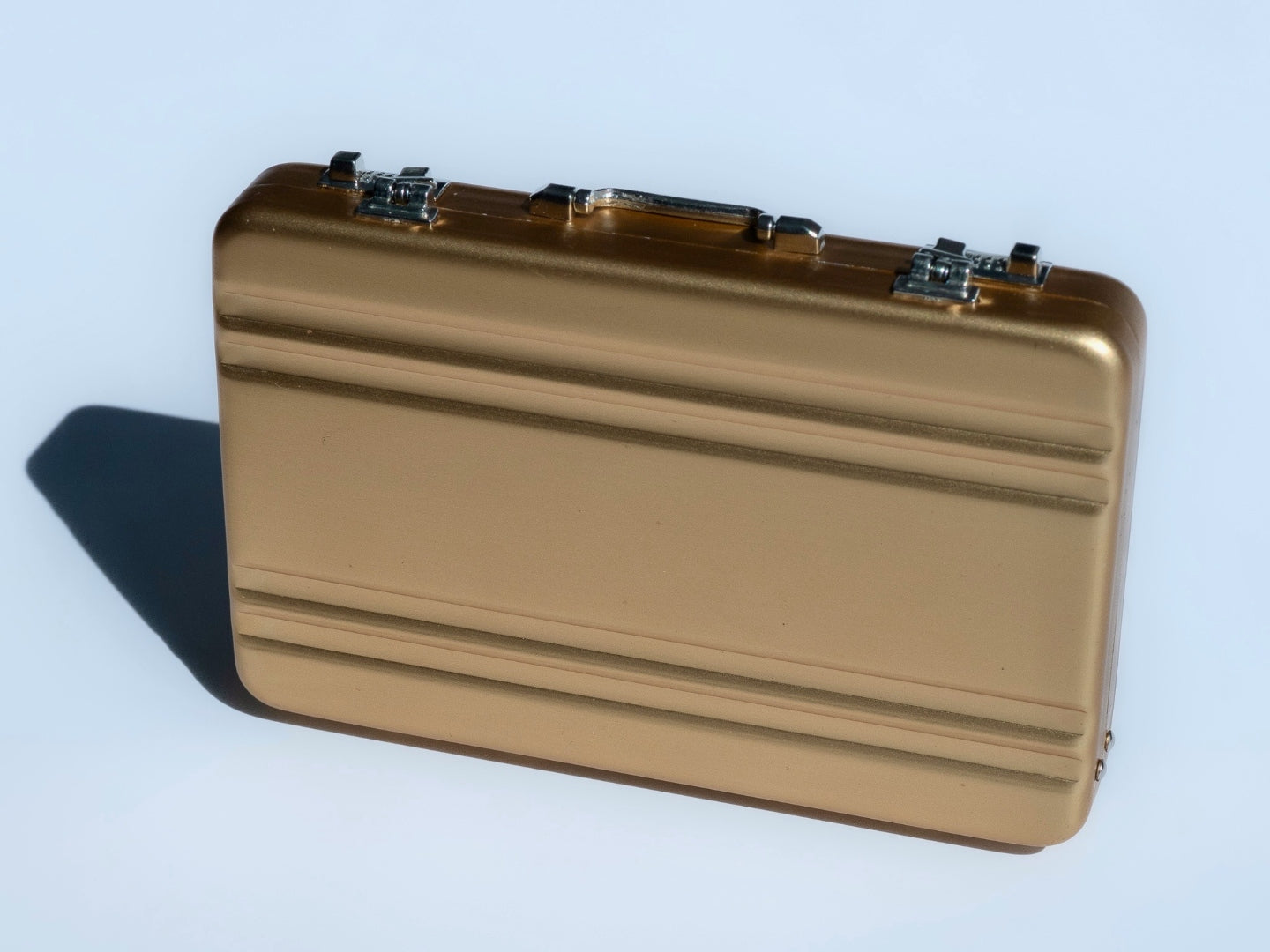 Gold briefcase dramatic angle